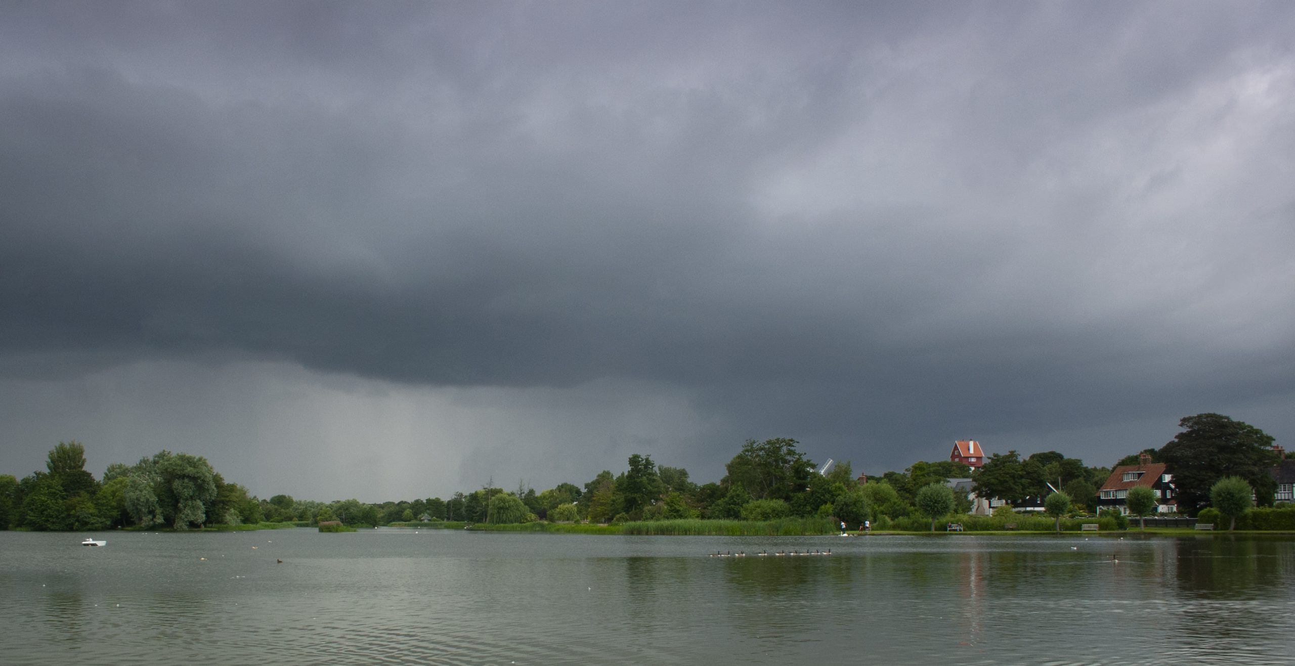 Stormy summer skies at Thorpeness Meare, Suffolk, UK